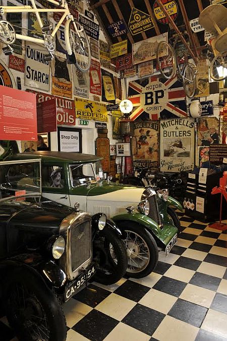 Some of the vintage vehicles and signs at the Cotswold Motoring Museum. 